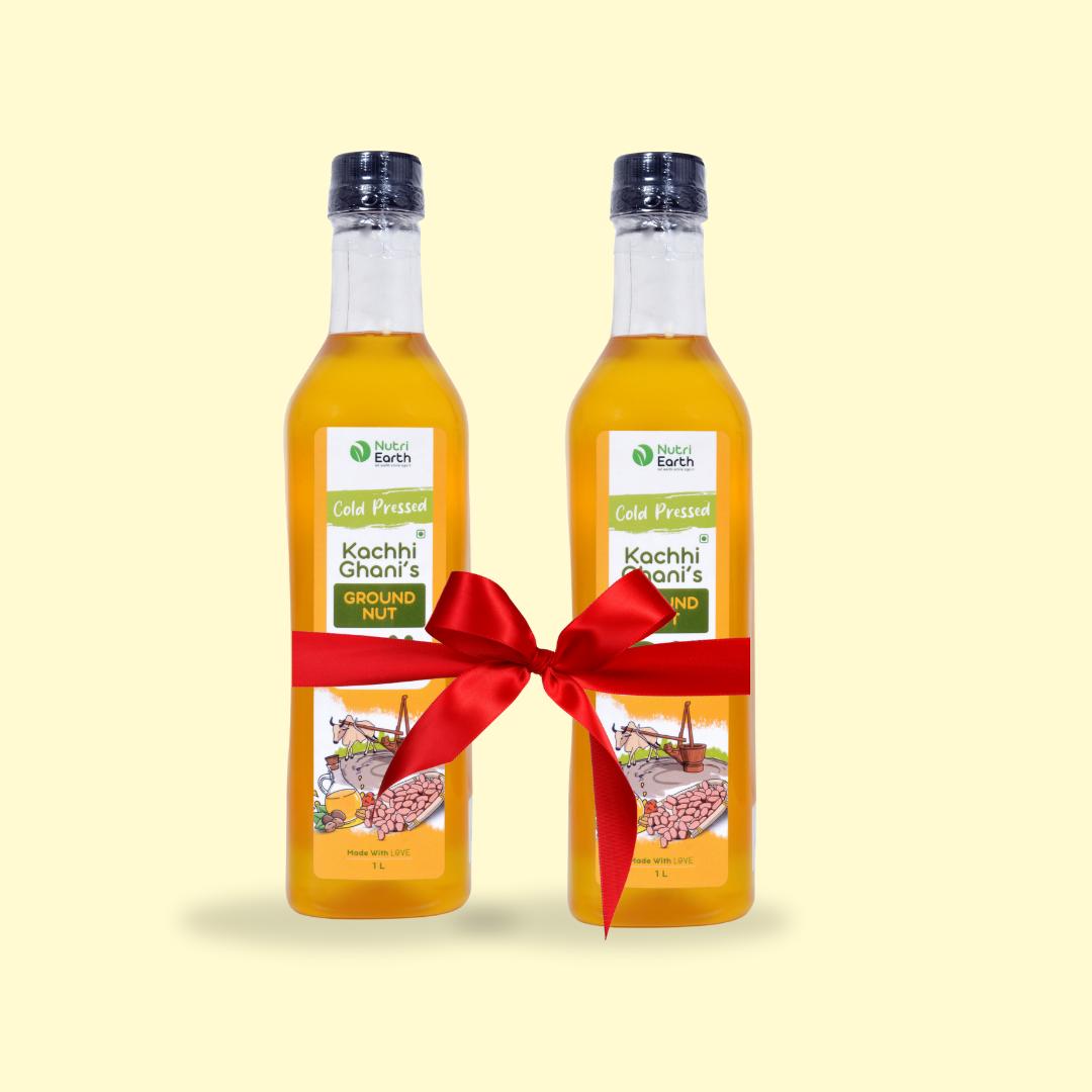 Nutriearth Wooden Cold Pressed Ground Nut Oil in Bottle with black lid, bundled with a red ribbon. Premium Wooden Cold Pressed Oil Buy Online.