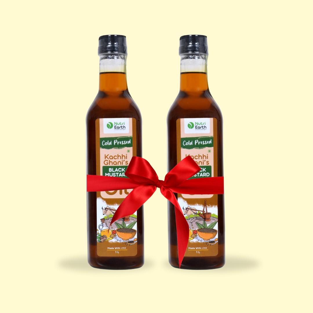 Nutriearth Wooden Cold Pressed Black Mustard Oil in bottle with black lid, Bundled with red ribbiion. Premium wood cold pressed oil buy online.