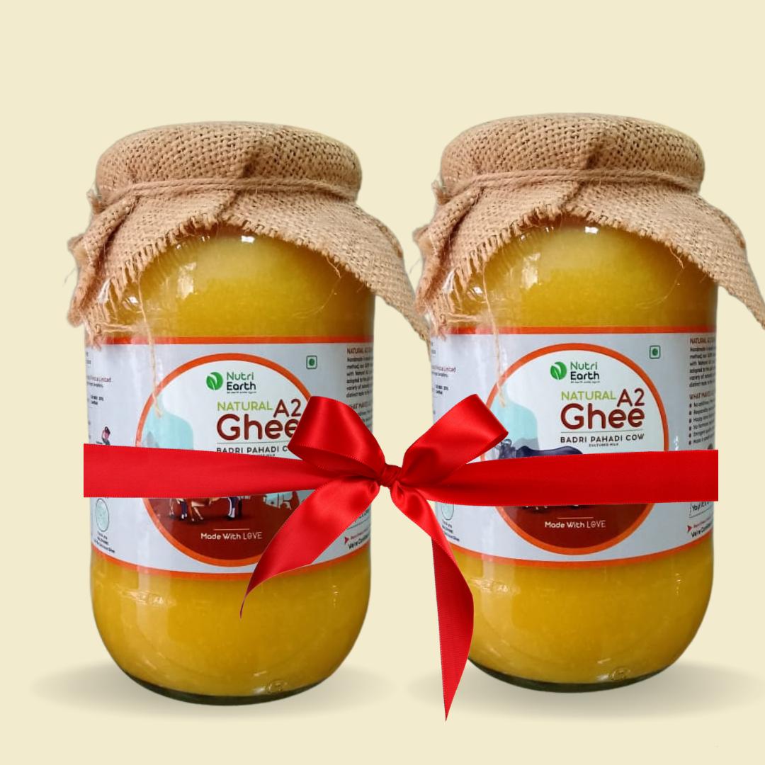 Nutriearth A2 Cow Ghee Badri in glass jars with jute covers, bundled with a red ribbon. Premium dairy product from (Himalayan Cow) cow milk.
