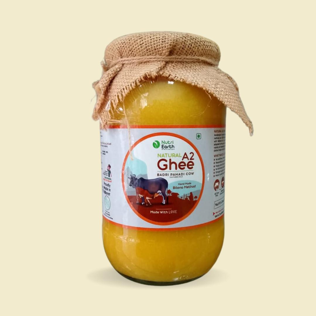 Nutriearth A2 Cow Ghee Badri in a glass jar with jute cover, made from Himalayan Badri cows, rich in A2 protein. Premium dairy product for healthy cooking.