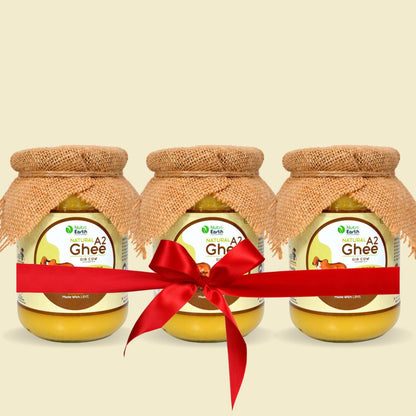 Nutriearth A2 Cow Ghee Gir  in glass jars with jute covers, bundled with a red ribbon. Premium dairy product from Gir cow milk.